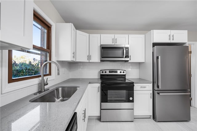 kitchen with stainless steel appliances, sink, and white cabinets