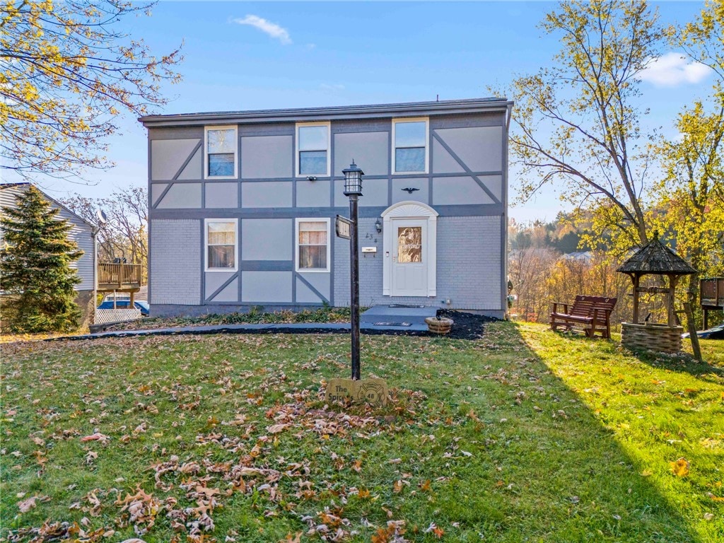 back of property with a gazebo and a yard