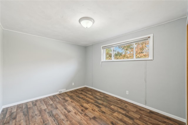 unfurnished room featuring crown molding and dark hardwood / wood-style floors