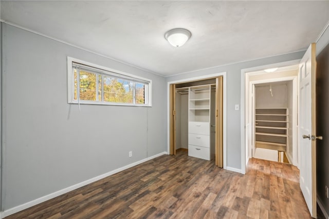 unfurnished bedroom featuring a closet and dark hardwood / wood-style floors