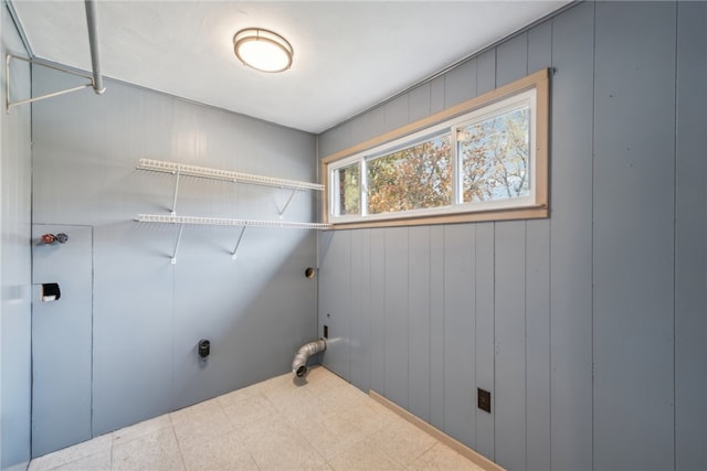 laundry area featuring wood walls