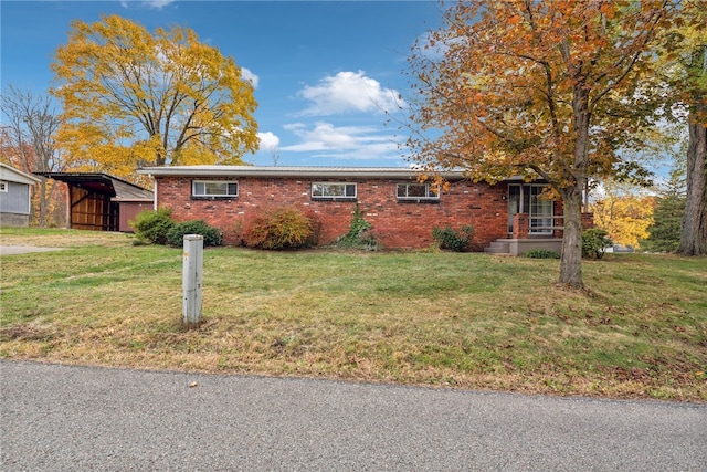 ranch-style home with a front lawn