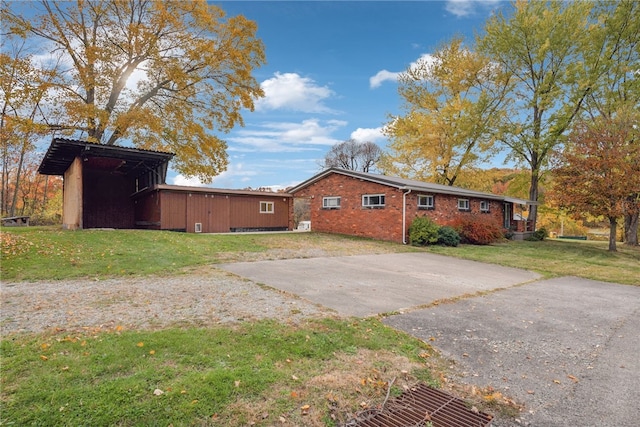 view of side of property with a lawn