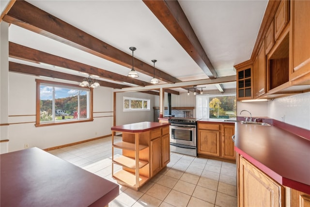 kitchen with pendant lighting, stainless steel electric range, a center island, and plenty of natural light