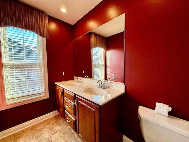 bathroom featuring toilet, vanity, and tile patterned floors