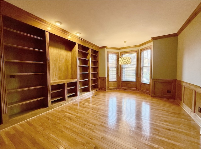 unfurnished room with crown molding and light wood-type flooring