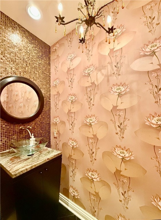 bathroom featuring vanity, decorative backsplash, and tile walls