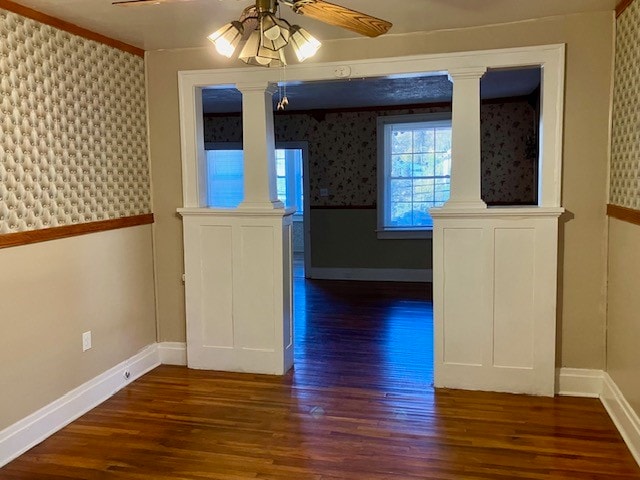 unfurnished dining area featuring ornamental molding, dark hardwood / wood-style floors, and ceiling fan