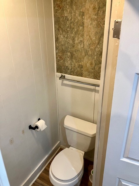 bathroom with toilet and hardwood / wood-style floors