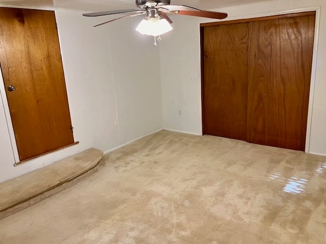 unfurnished bedroom featuring light colored carpet and ceiling fan