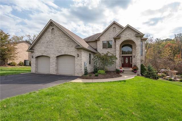 french country inspired facade with a front yard, central AC, and a garage