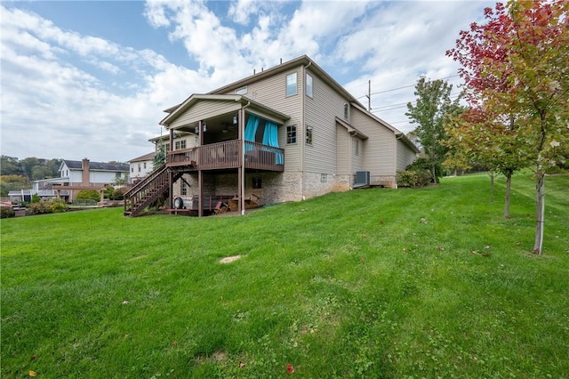 rear view of house with a lawn, central air condition unit, and a deck