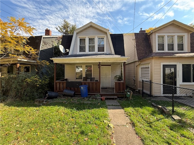 view of front of property with covered porch and a front lawn