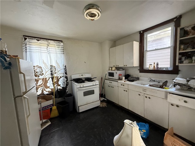 kitchen with white cabinetry, sink, and white appliances