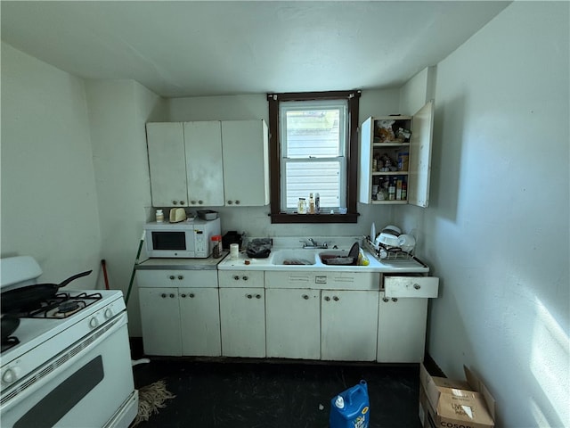 kitchen with white cabinets, sink, and white appliances