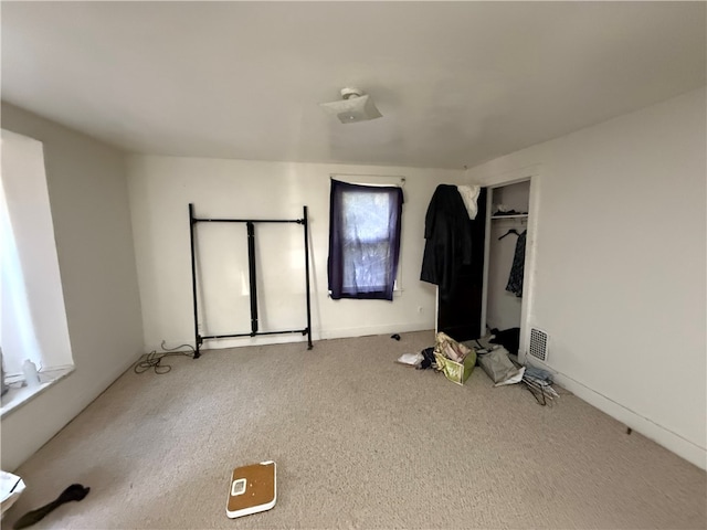 unfurnished bedroom featuring a closet and carpet floors