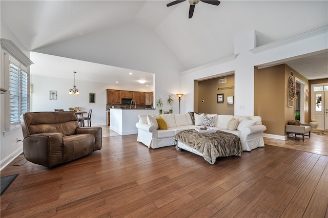 living room featuring dark wood-type flooring, high vaulted ceiling, and plenty of natural light