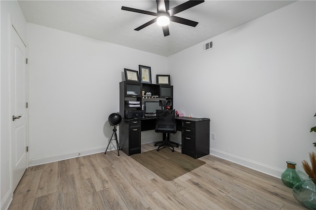 office with light hardwood / wood-style floors and ceiling fan