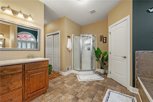 bathroom with vanity and a shower with shower door