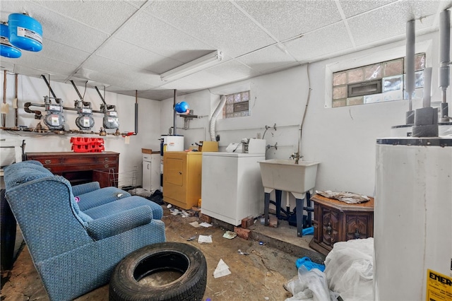 interior space featuring a workshop area, a paneled ceiling, and separate washer and dryer