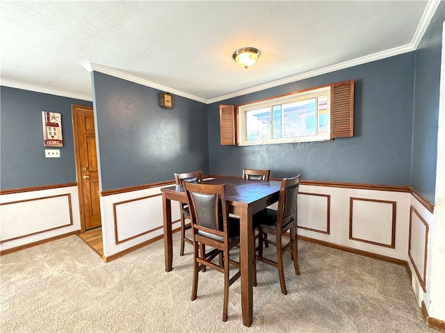 carpeted dining room with ornamental molding and a textured ceiling