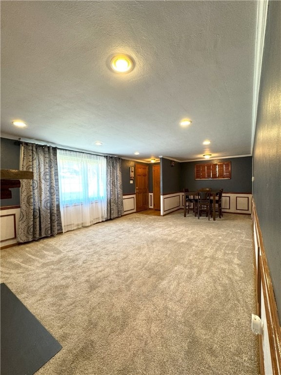 interior space featuring ornamental molding and a textured ceiling