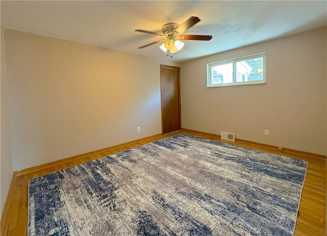 empty room featuring ceiling fan and wood-type flooring