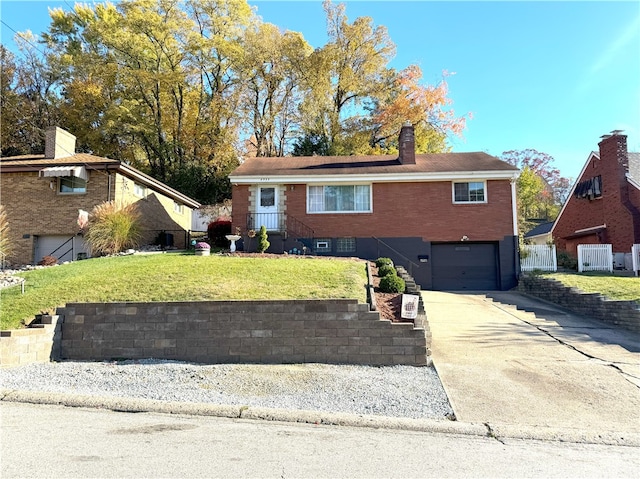 view of front facade with a front yard and a garage