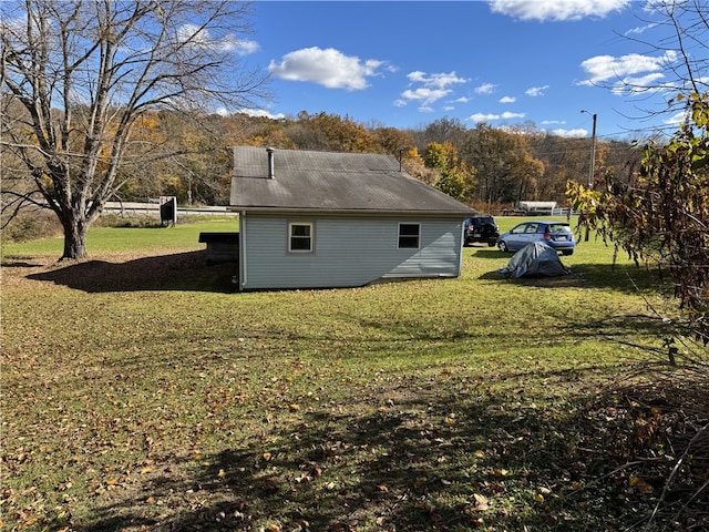 view of property exterior with a lawn