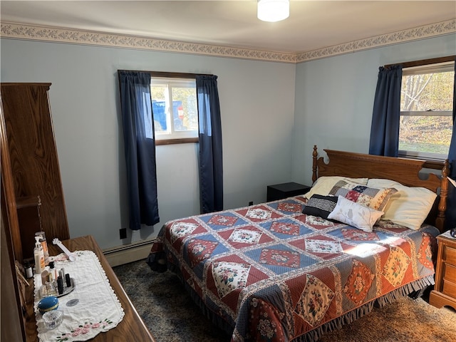 bedroom featuring a baseboard radiator, dark wood-type flooring, and multiple windows