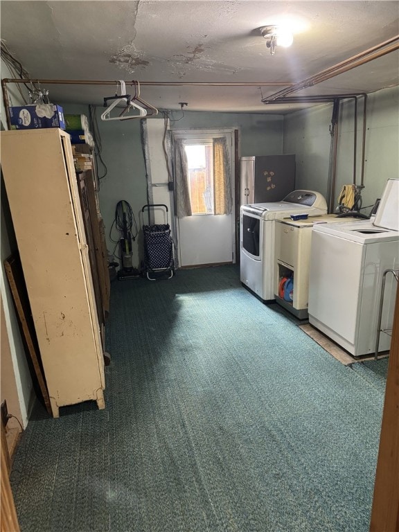 laundry area with dark carpet and washing machine and dryer