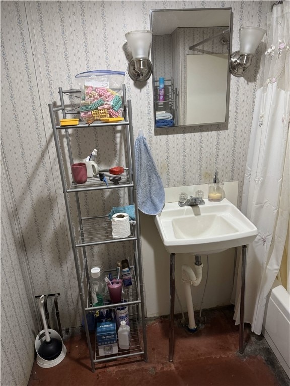 bathroom featuring shower / bathtub combination with curtain and sink