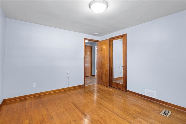 unfurnished room with light wood-type flooring