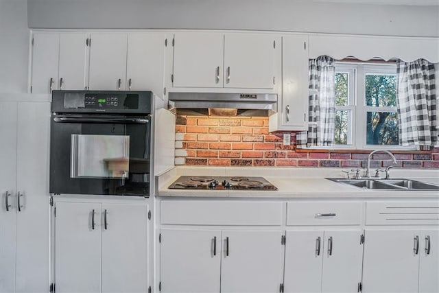 kitchen with decorative backsplash, sink, white cabinets, and black appliances