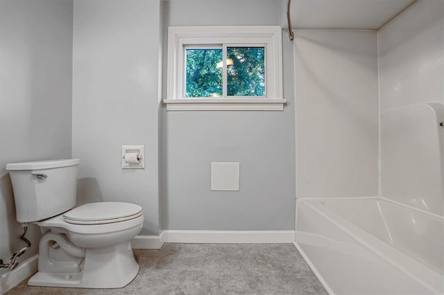 bathroom featuring toilet and a tub