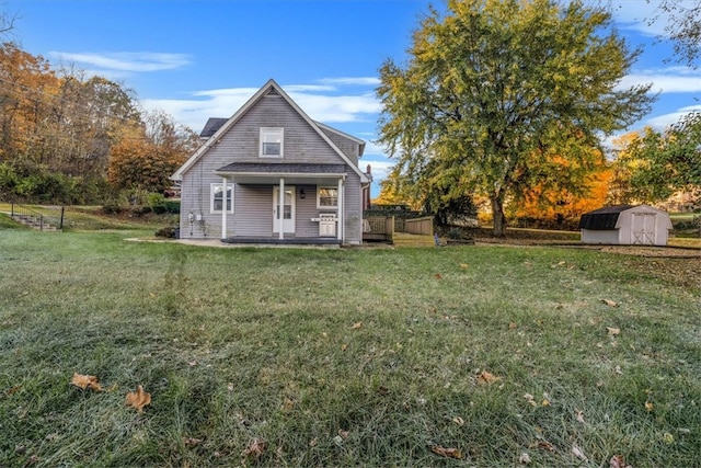 back of house featuring a lawn and a storage shed