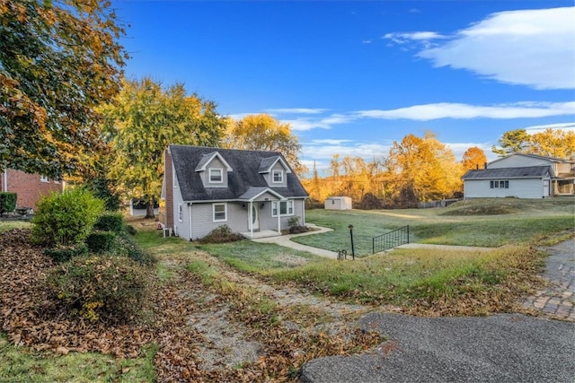 view of side of property featuring a lawn and a storage unit