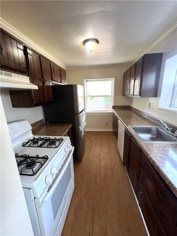 kitchen featuring white appliances, sink, hardwood / wood-style floors, dark brown cabinetry, and ornamental molding