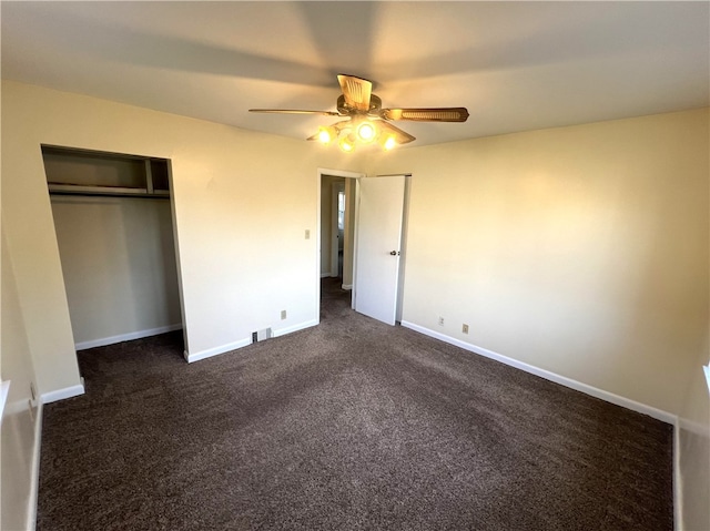 unfurnished bedroom featuring a closet, ceiling fan, and dark carpet