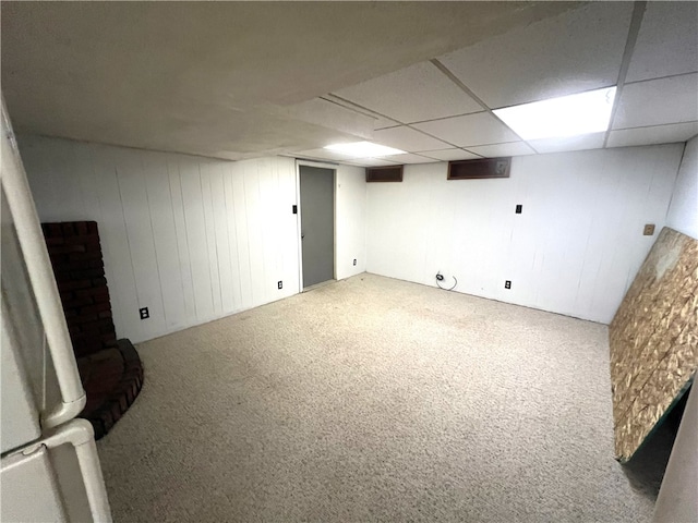 basement featuring carpet floors and a drop ceiling