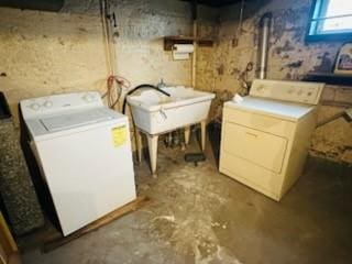 laundry room featuring laundry area, a sink, and washer and clothes dryer