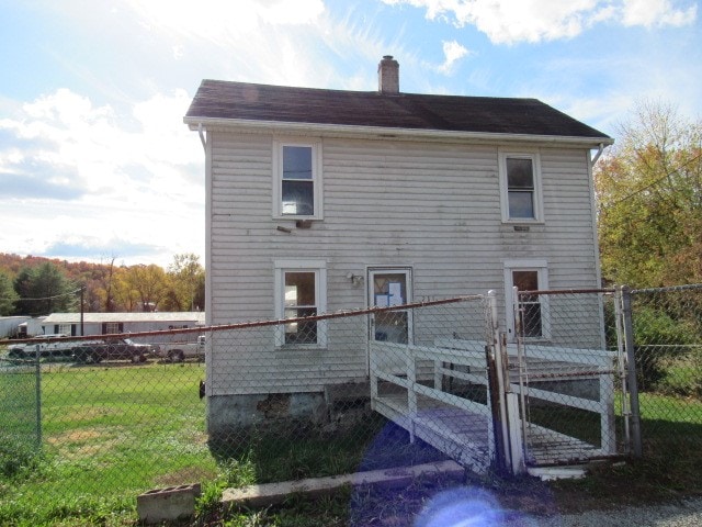 back of property featuring a yard