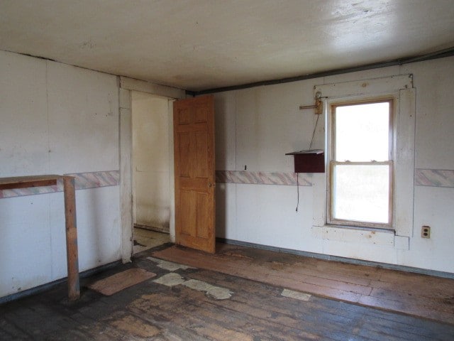 empty room featuring dark hardwood / wood-style flooring