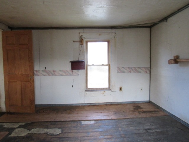 unfurnished room featuring dark hardwood / wood-style flooring