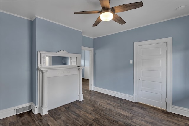 empty room with ornamental molding, dark wood-type flooring, and ceiling fan