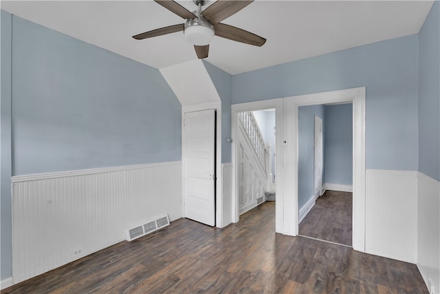 unfurnished room featuring lofted ceiling, dark hardwood / wood-style floors, and ceiling fan