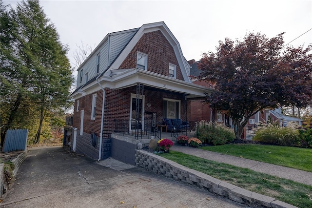 view of front of home with a front lawn and a porch