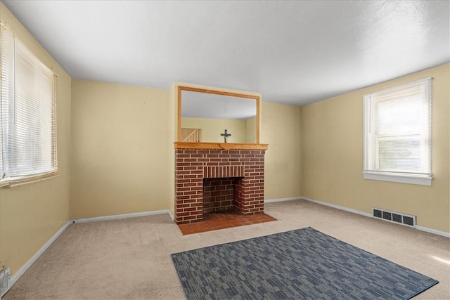 living room featuring light carpet and a brick fireplace