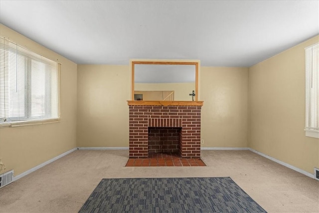 unfurnished living room featuring a fireplace and carpet floors