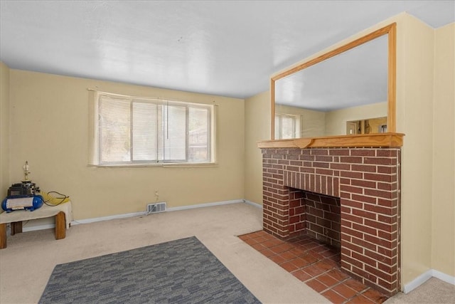 living room with carpet and a brick fireplace